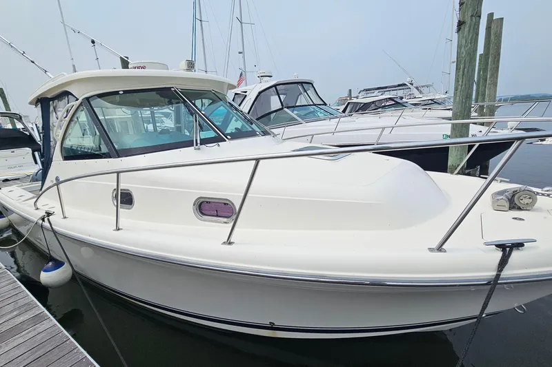 Slide: The Image of 2009 Pursuit OS 315 Offshore boat docked at marina, side view. - 9