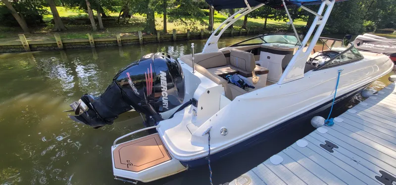 Slide: The Image of 2017 Sea Ray SDX 240 Outboard boat docked, featuring a sleek design and powerful Mercury engine. - 16