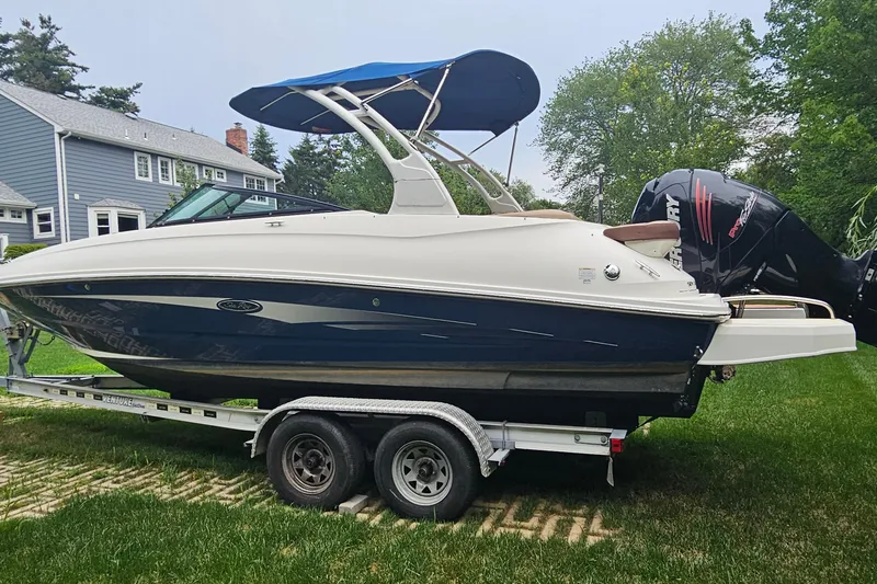 Slide: The Image of 2017 Sea Ray SDX 240 Outboard boat on trailer, parked on grass. - 18