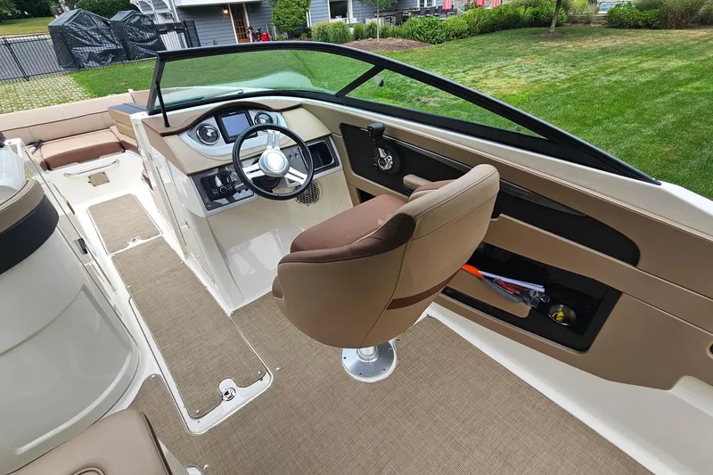 Slide: The Image of 2017 Sea Ray SDX 240 Outboard boat interior with helm, seating, and dashboard. - 26