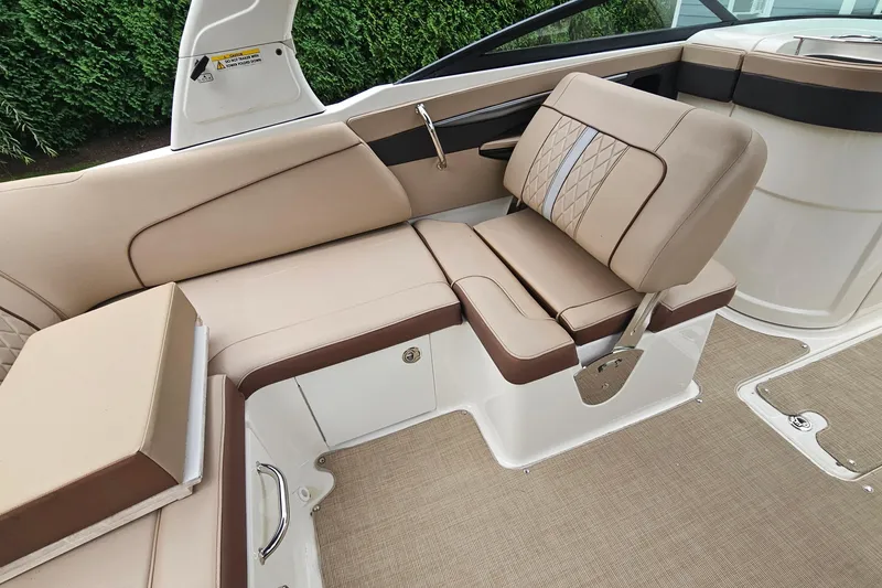 Slide: The Image of 2017 Sea Ray SDX 240 Outboard boat interior with beige and brown seating. - 28