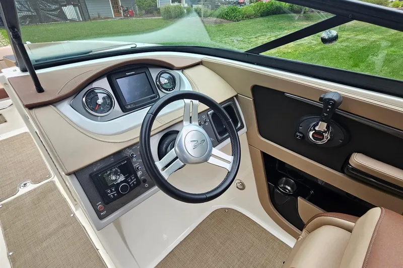 Slide: The Image of 2017 Sea Ray SDX 240 Outboard dashboard with steering wheel and control panel. - 29