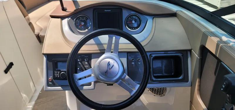 Slide: The Image of 2017 Sea Ray SDX 240 Outboard dashboard with steering wheel and instrument panel. - 30