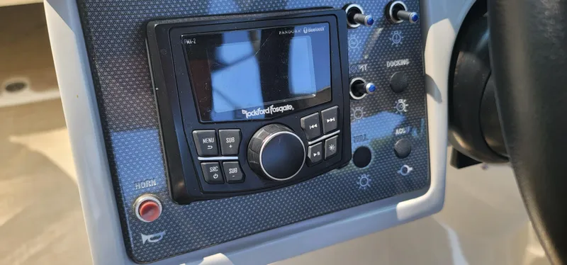 Slide: The Image of Control panel of a 2017 Sea Ray SDX 240 Outboard boat with Rockford Fosgate audio system. - 31