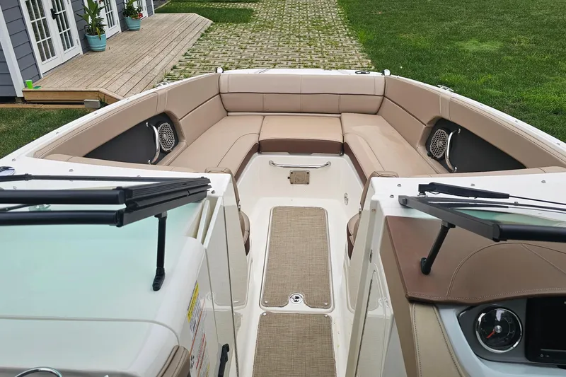 Slide: The Image of 2017 Sea Ray SDX 240 Outboard boat interior with beige seating and modern dashboard. - 34