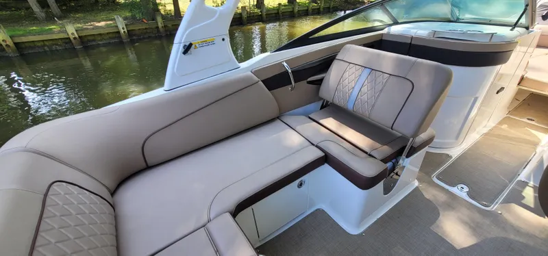 Slide: The Image of 2017 Sea Ray SDX 240 Outboard boat interior with luxurious seating by the water. - 9