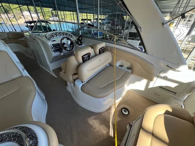 Slide: The Image of Interior of 2012 Crownline 325 SS boat with beige seating and modern dashboard. - 11
