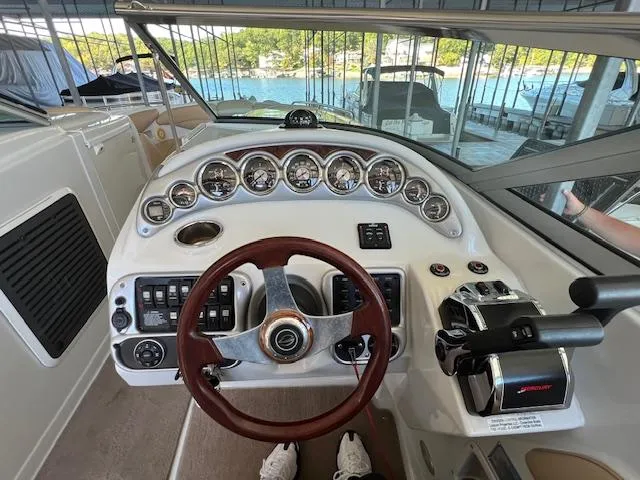 Slide: The Image of Cockpit of 2012 Crownline 325 SS boat with steering wheel and control panel. - 15