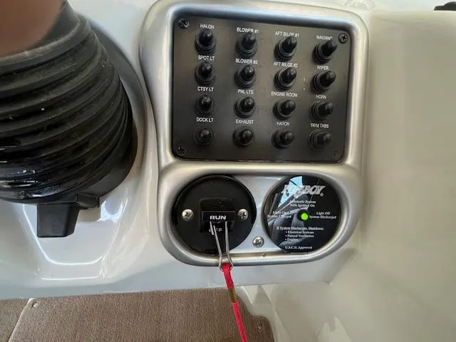 Slide: The Image of Control panel of a 2012 Crownline 325 SS boat with various switches and a safety lanyard. - 19