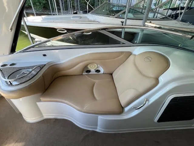 Slide: The Image of 2012 Crownline 325 SS boat interior with tan leather seating and sleek design. - 21