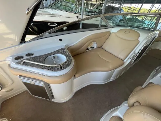 Slide: The Image of 2012 Crownline 325 SS boat interior with beige seating and built-in sink. - 22