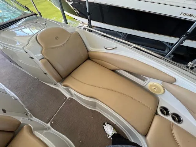 Slide: The Image of 2012 Crownline 325 SS boat interior with tan leather seating and cup holders. - 27