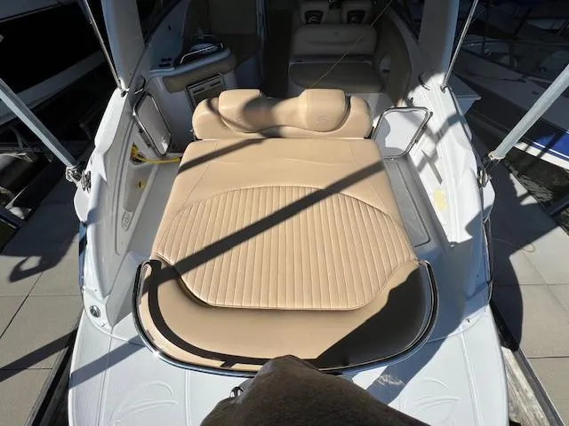Slide: The Image of 2012 Crownline 325 SS boat with beige seating and sleek interior design. - 29