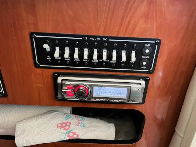 Slide: The Image of Control panel and stereo system in a 2012 Crownline 325 SS boat. - 37