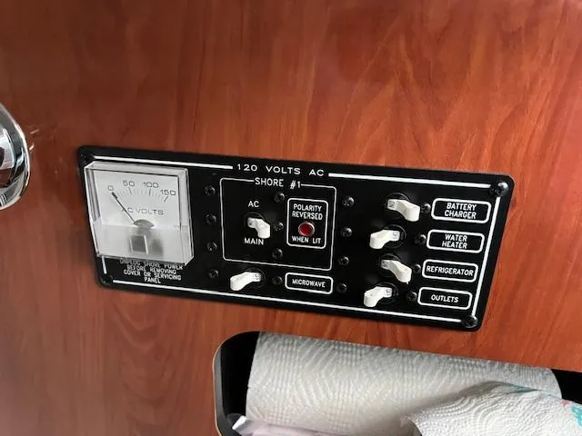 Slide: The Image of Control panel of a 2012 Crownline 325 SS boat, featuring various electrical switches. - 38