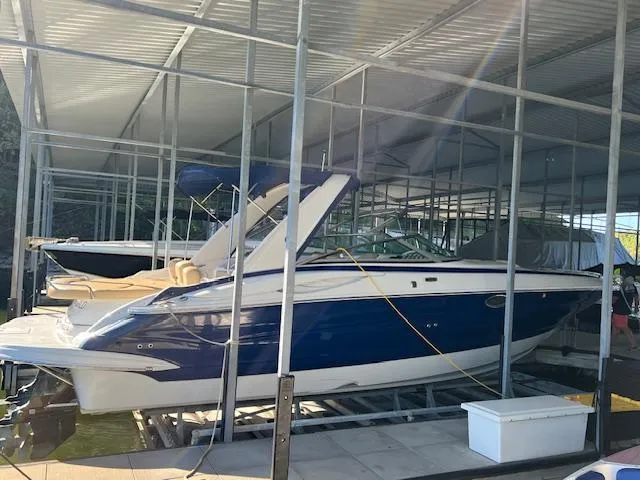Slide: The Image of 2012 Crownline 325 SS boat docked in a covered marina. - 4