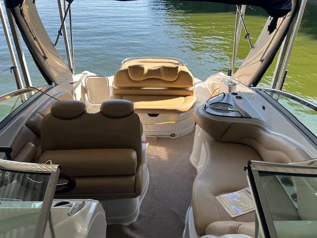 Slide: The Image of 2012 Crownline 325 SS boat interior with beige seating and lake view. - 8