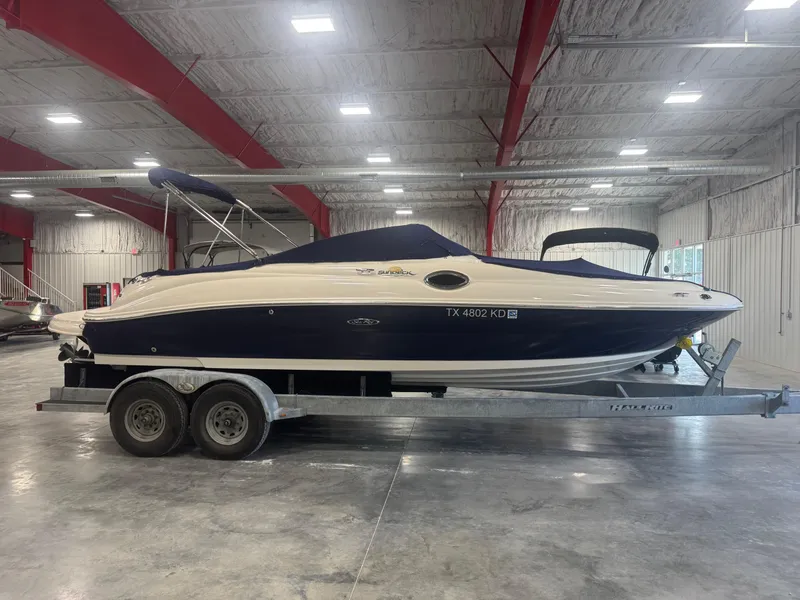 Slide: The Image of 2005 Sea Ray 240 Sundeck boat on trailer in indoor storage facility. - 17