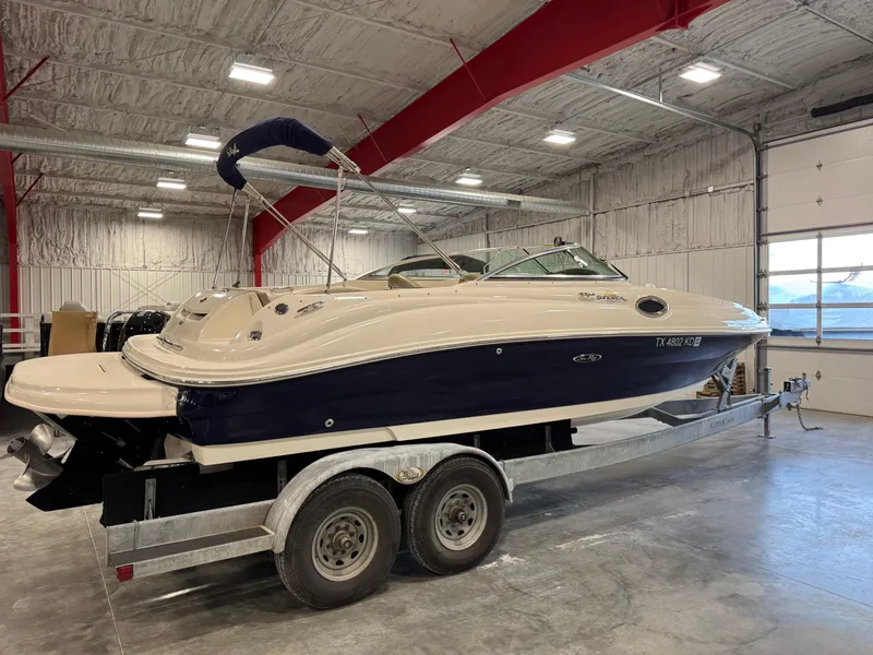 Slide: The Image of 2005 Sea Ray 240 Sundeck boat on trailer in indoor storage facility. - 3