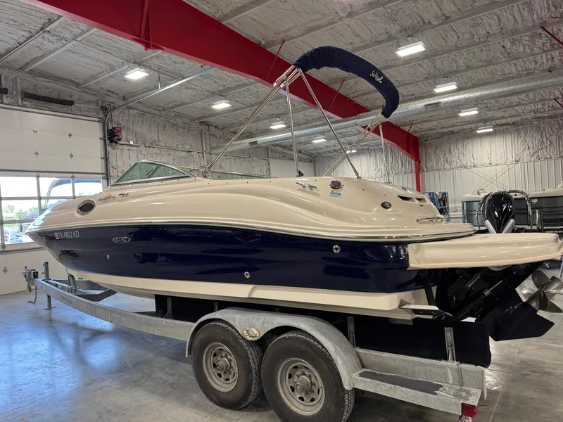 Slide: The Image of 2005 Sea Ray 240 Sundeck boat on trailer in indoor storage facility. - 4