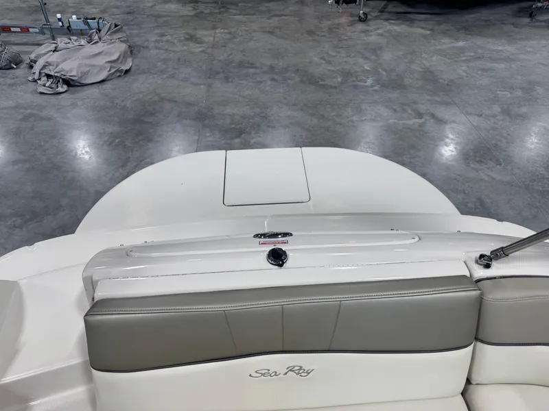 Slide: The Image of 2005 Sea Ray 240 Sundeck boat interior with gray and white seating. - 7
