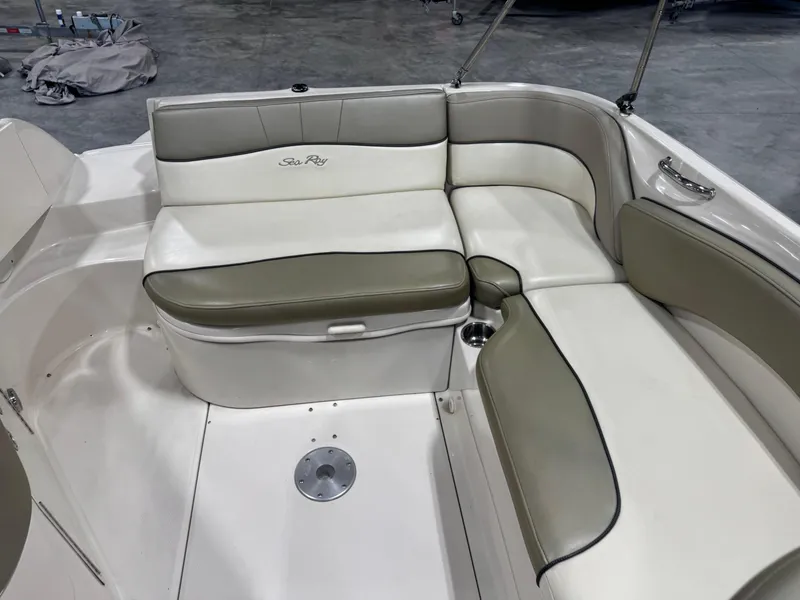 Slide: The Image of 2005 Sea Ray 240 Sundeck interior seating with beige and white upholstery. - 8
