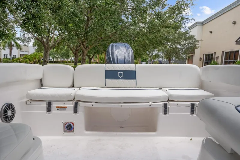 Slide: The Image of 2025 Sea Fox 228 Traveler boat interior with white seating and outdoor view. - 8