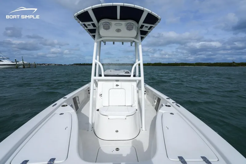 Slide: The Image of 2023 Sea Pro 208 Bay boat on water, featuring a sleek design and spacious deck. - 4