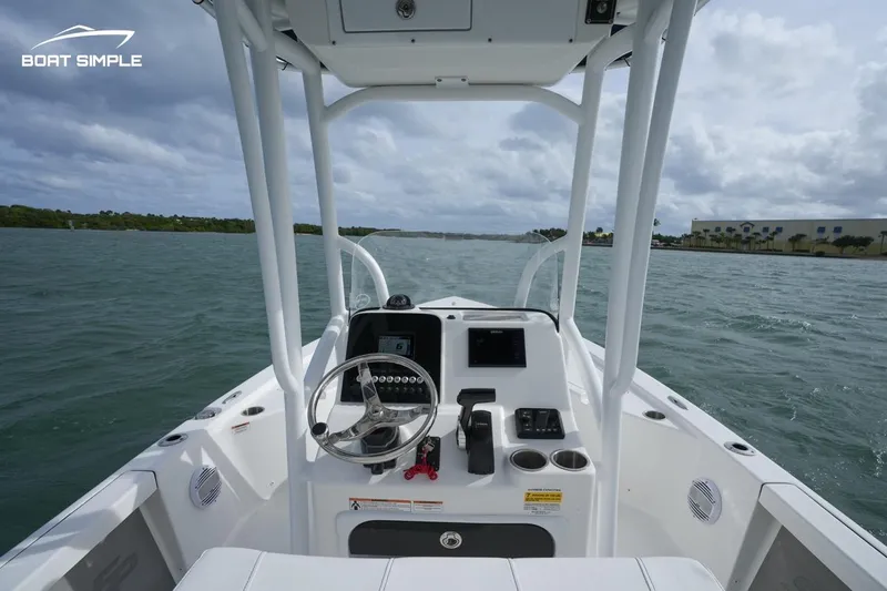 Slide: The Image of 2023 Sea Pro 208 Bay boat interior with steering console on open water. - 6