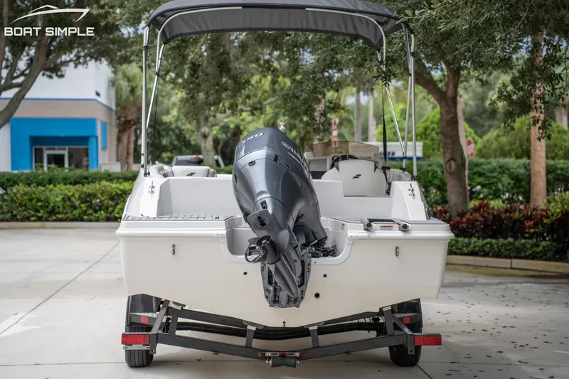 Slide: The Image of 2024 Starcraft SVX 191 OB boat on trailer, rear view, parked outdoors. - 4