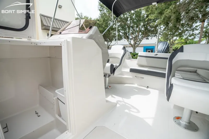Slide: The Image of 2023 Starcraft SVX 231 OB DH boat interior with seating and storage compartments. - 10