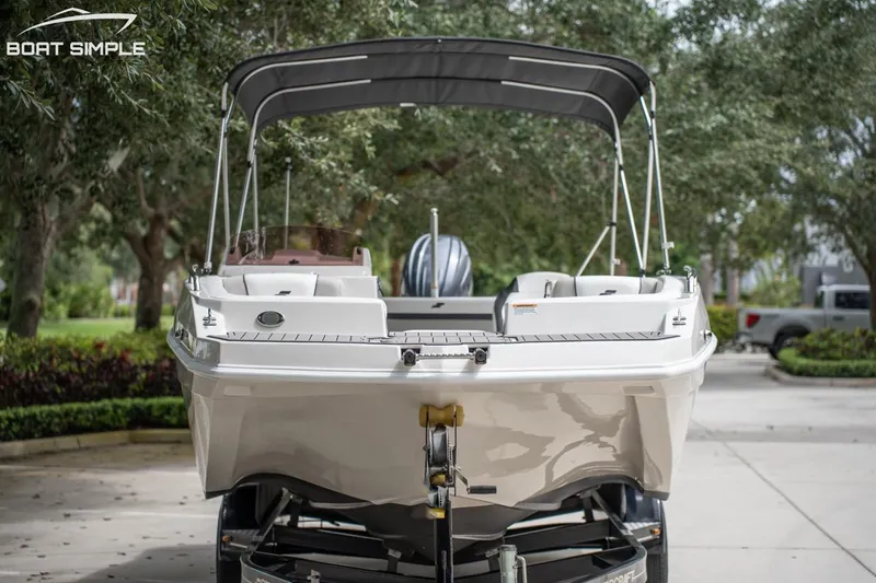 Slide: The Image of 2023 Starcraft SVX 231 OB DH boat on trailer, parked outdoors. - 8