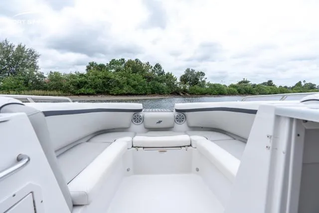 Slide: The Image of 2023 Starcraft SVX 231 OB DH boat interior with white seating and scenic water view. - 11