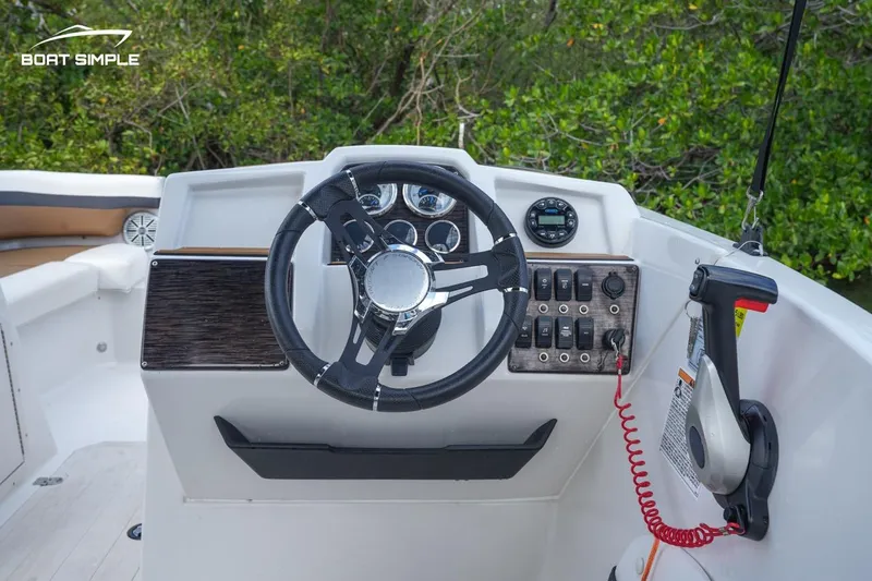 Slide: The Image of 2023 Starcraft SVX 210 boat dashboard with steering wheel and control panel. - 4