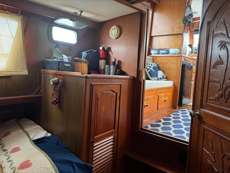 Slide: The Image of Interior of 1981 Marine Trader 34 Double Cabin with wood paneling and cozy decor. - 12