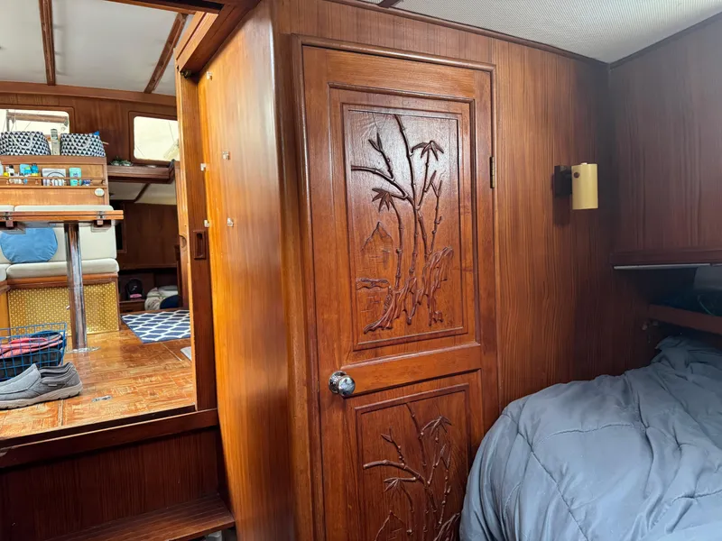 Slide: The Image of 1981 Marine Trader 34 Double Cabin interior with wood paneling and carved door. - 14