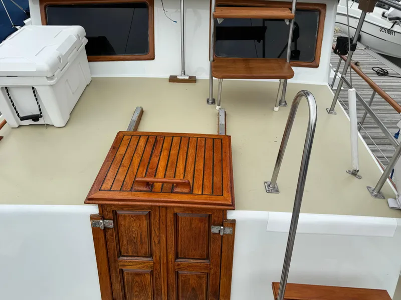 Slide: The Image of 1981 Marine Trader 34 Double Cabin deck with wooden hatch and steps. - 20