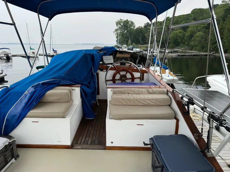 Slide: The Image of 1981 Marine Trader 34 Double Cabin boat with blue canopy and dockside view. - 22
