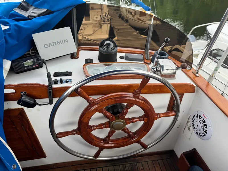 Slide: The Image of 1981 Marine Trader 34 Double Cabin helm with wooden wheel, Garmin GPS, and navigation equipment. - 23