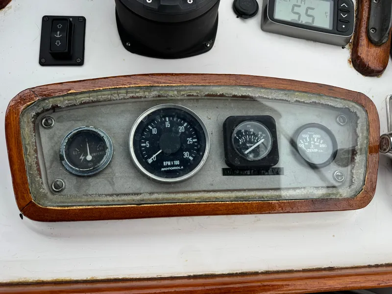 Slide: The Image of 1981 Marine Trader 34 Double Cabin dashboard with gauges and controls. - 26