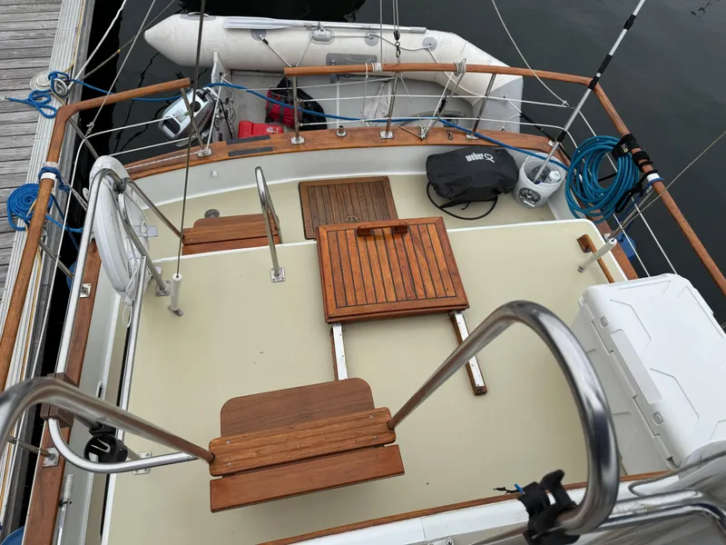 Slide: The Image of 1981 Marine Trader 34 Double Cabin deck with wooden seating and dinghy. - 28