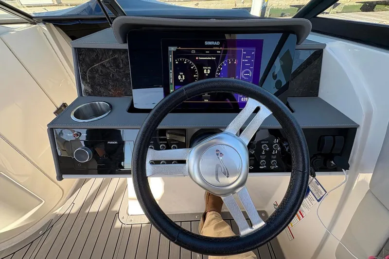 Slide: The Image of 2021 Sea Ray SDX 270 Outboard dashboard with steering wheel and digital display. - 16