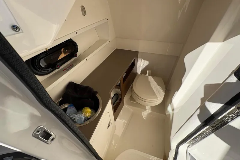 Slide: The Image of 2021 Sea Ray SDX 270 Outboard boat interior with compact bathroom amenities. - 17