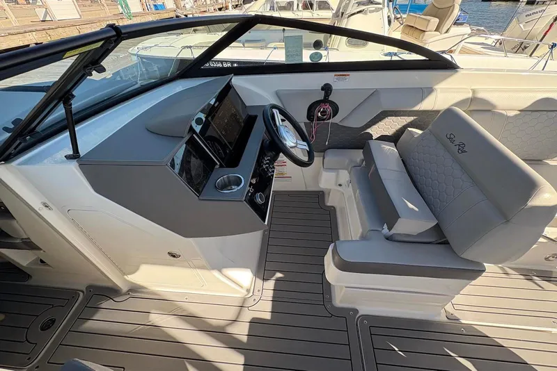 Slide: The Image of 2021 Sea Ray SDX 270 Outboard boat interior with helm and seating area. - 18