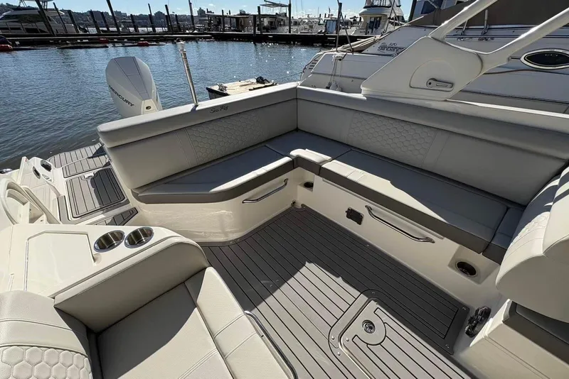 Slide: The Image of 2021 Sea Ray SDX 270 Outboard boat interior with spacious seating and elegant design. - 20