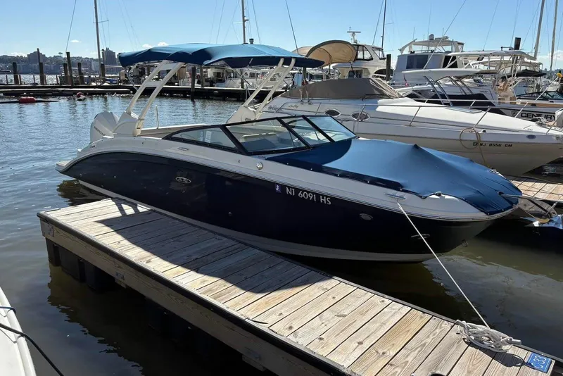 Slide: The Image of 2021 Sea Ray SDX 270 Outboard boat docked at marina. - 26
