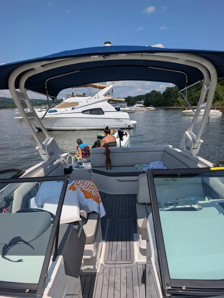 Slide: The Image of 2021 Sea Ray SDX 270 Outboard boat interior with spacious seating and elegant design. - 6