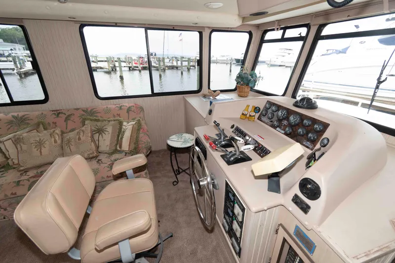 Slide: The Image of Interior of a 2004 Gibson 47 Classic boat with helm and seating area. - 10