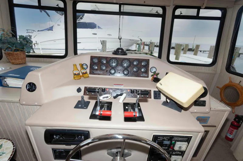 Slide: The Image of Control panel of a 2004 Gibson 47 Classic boat with gauges and steering wheel. - 11