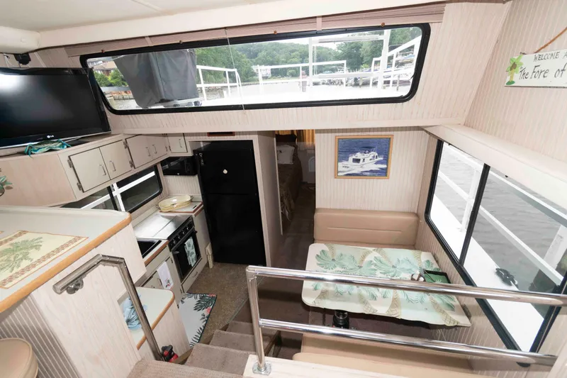 Slide: The Image of Interior of a 2004 Gibson 47 Classic houseboat with kitchen, dining area, and large windows. - 12